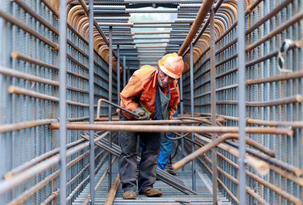 A worker prepares steel bars on the construction site of the Zhangjinggao Yangtze River Bridge on Mazhou Island in Jingjiang, in China's eastern Jiangsu province on July 14, 2023. (STRINGER/AFP via Getty Images)