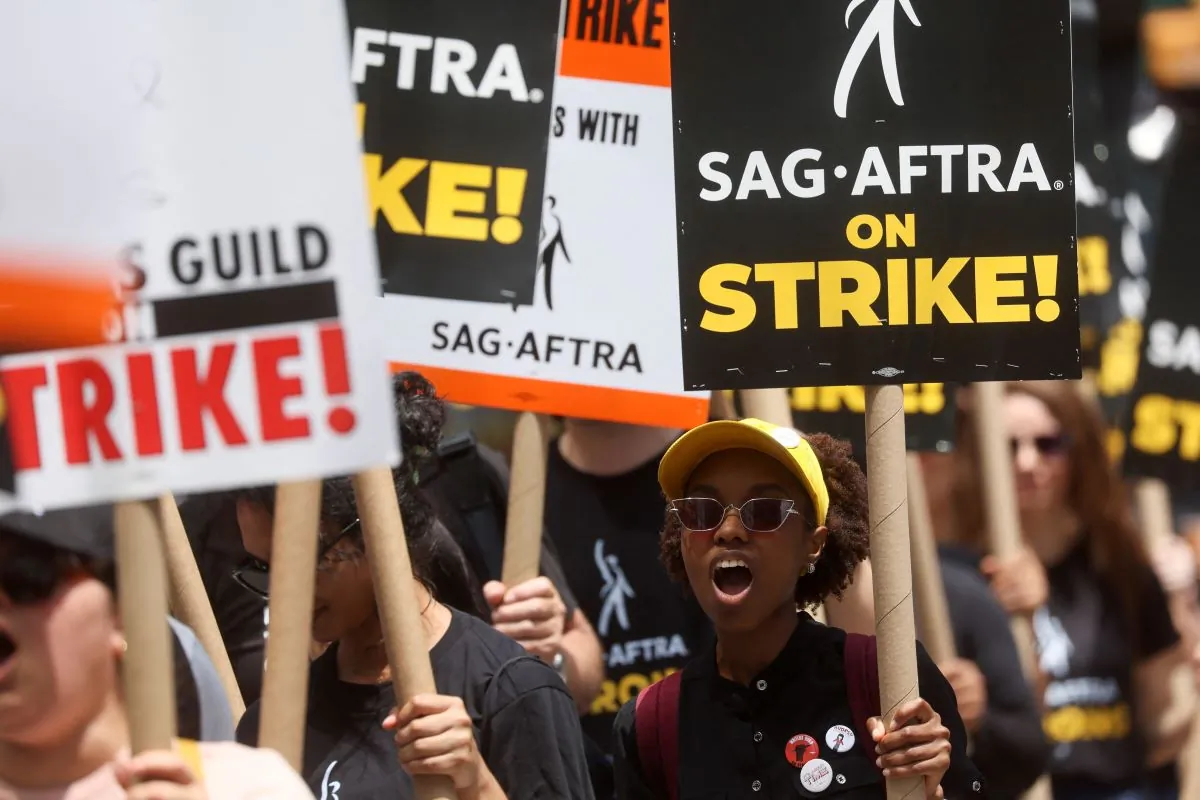 Striking Writers Guild of America and Screen Actors Guild members walk the picket line during their strike in New York City on July 14, 2023. (Brendan Mcdermid/Reuters)