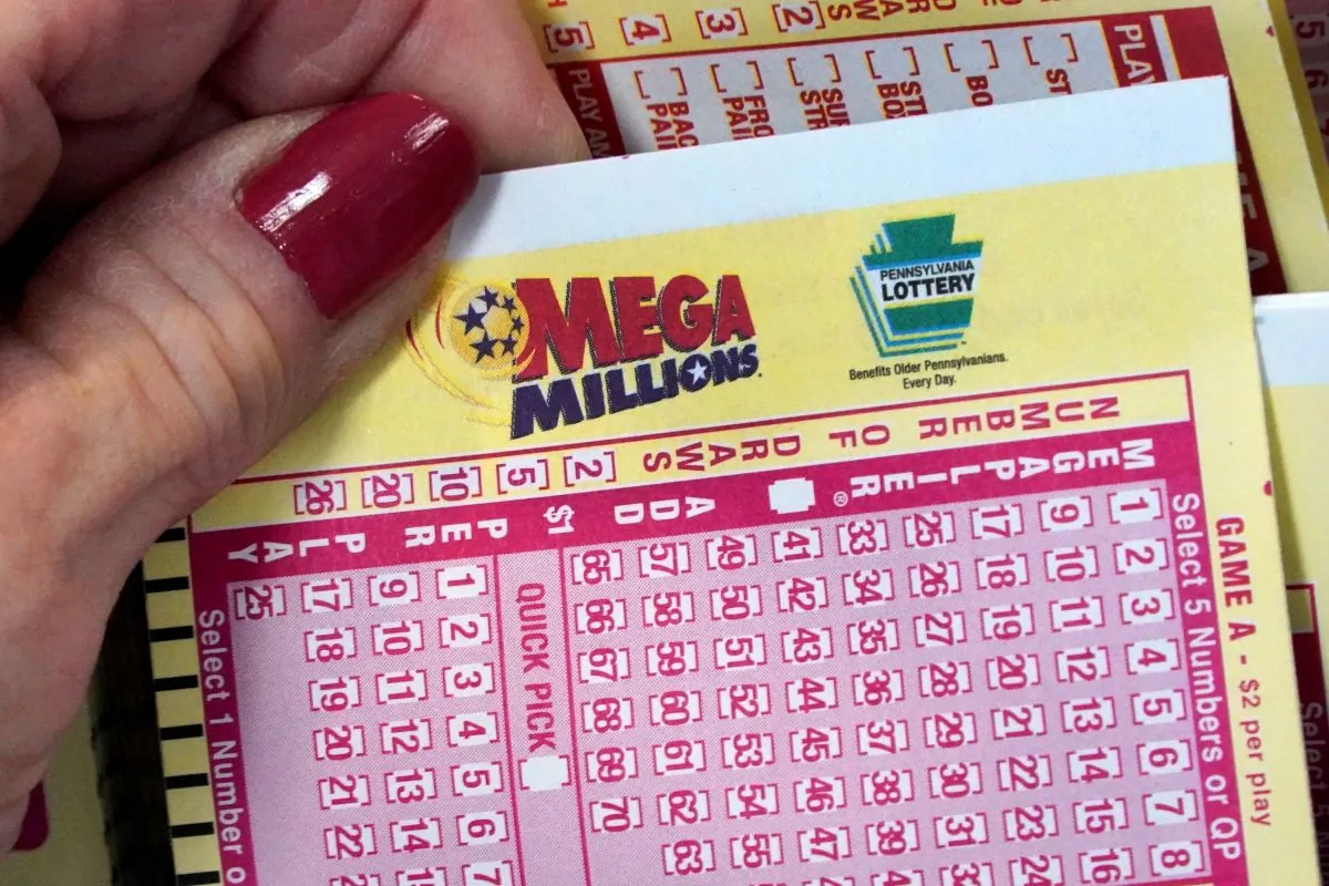 A Mega Millions wagering slip is held in Cranberry Township, Pa., on Jan. 12, 2023. (Gene J. Puskar/AP Photo)