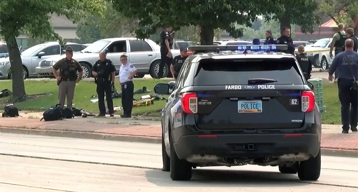 In this image from video, law enforcement officers work at the scene of a shooting in Fargo, N.D., on July 14, 2023. (WDAY-TV via AP)