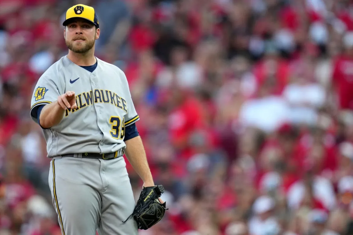 Milwaukee Brewers starting pitcher Corbin Burnes (39) works on his motion during a mound visit in the first inning during a baseball game between the Milwaukee Brewers and the Cincinnati Reds at Great American Ball Park in Cincinnati on July 14, 2023.