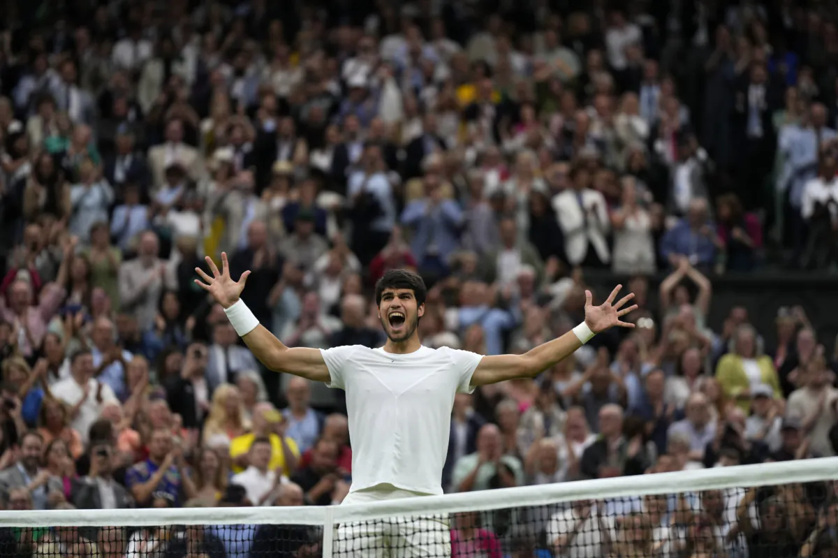 Spain's Carlos Alcaraz celebrates after beating Russia's Daniil Medvedev to win their men's singles semifinal match on day twelve of the Wimbledon tennis championships in London on July 14, 2023. (Alastair Grant/AP Photo)