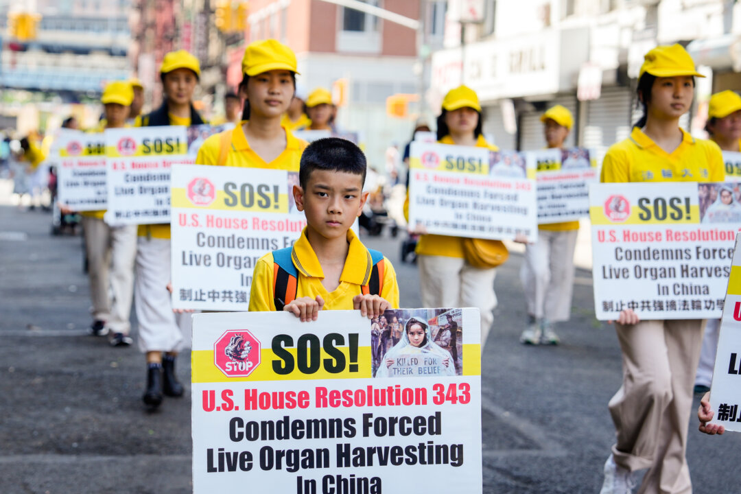 Falun Gong practitioners take part in a parade to commemorate the 24th anniversary of the persecution of the spiritual discipline in China, in New York's Chinatown on July 15, 2023. (Samira Bouaou/The Epoch Times)