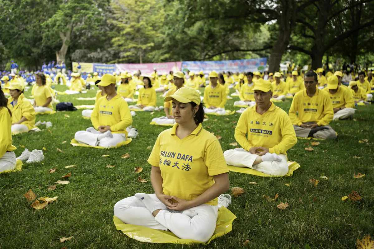 Falun Gong adherents perform the fifth exercise of the meditative practice at Queen's Park in Toronto, Ontario, on July 15, 2023. Hundreds of Falun Gong practitioners took part in a rally and a parade through the city's downtown area, calling on the Chinese regime to stop the ongoing persecution against the spiritual practice. (Evan Ning/The Epoch Times)