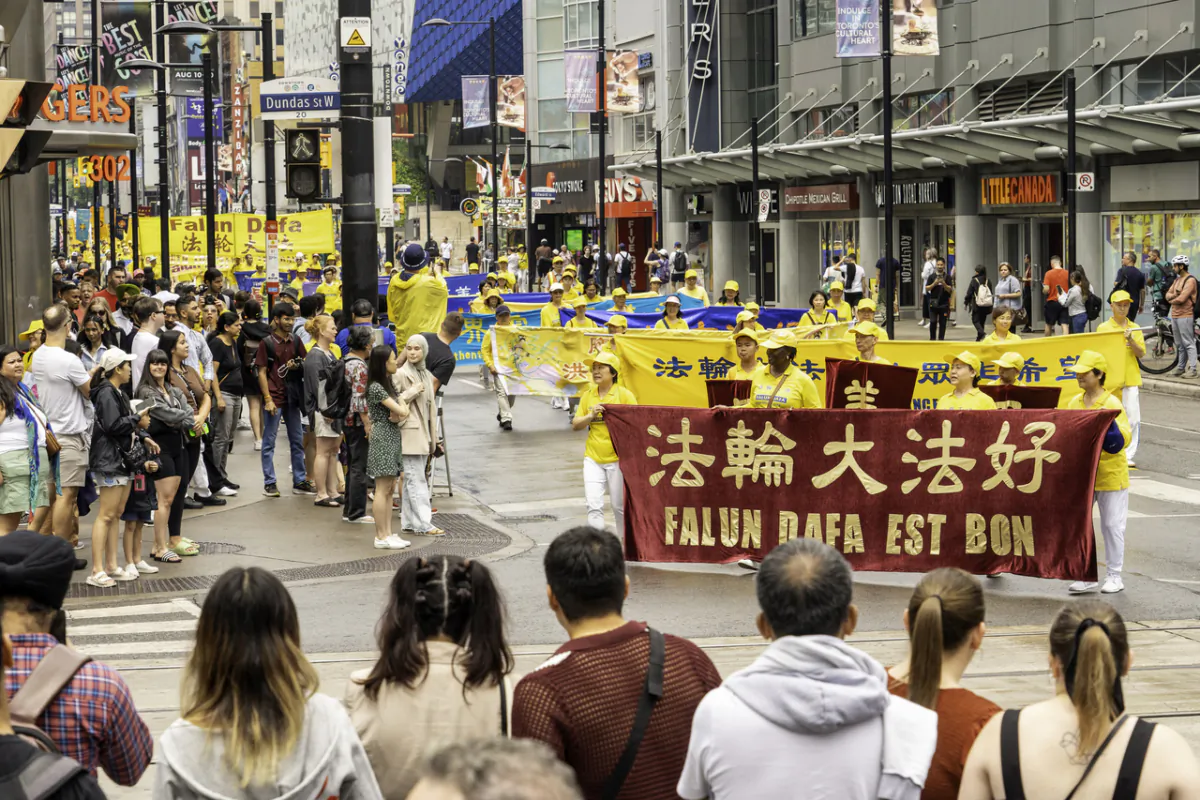 Hundreds of Falun Gong practitioners took part in a rally and a parade through downtown Toronto on July 15, 2023, to call on the Chinese regime to stop its persecution of Falun Gong. (Evan Ning/The Epoch Times)