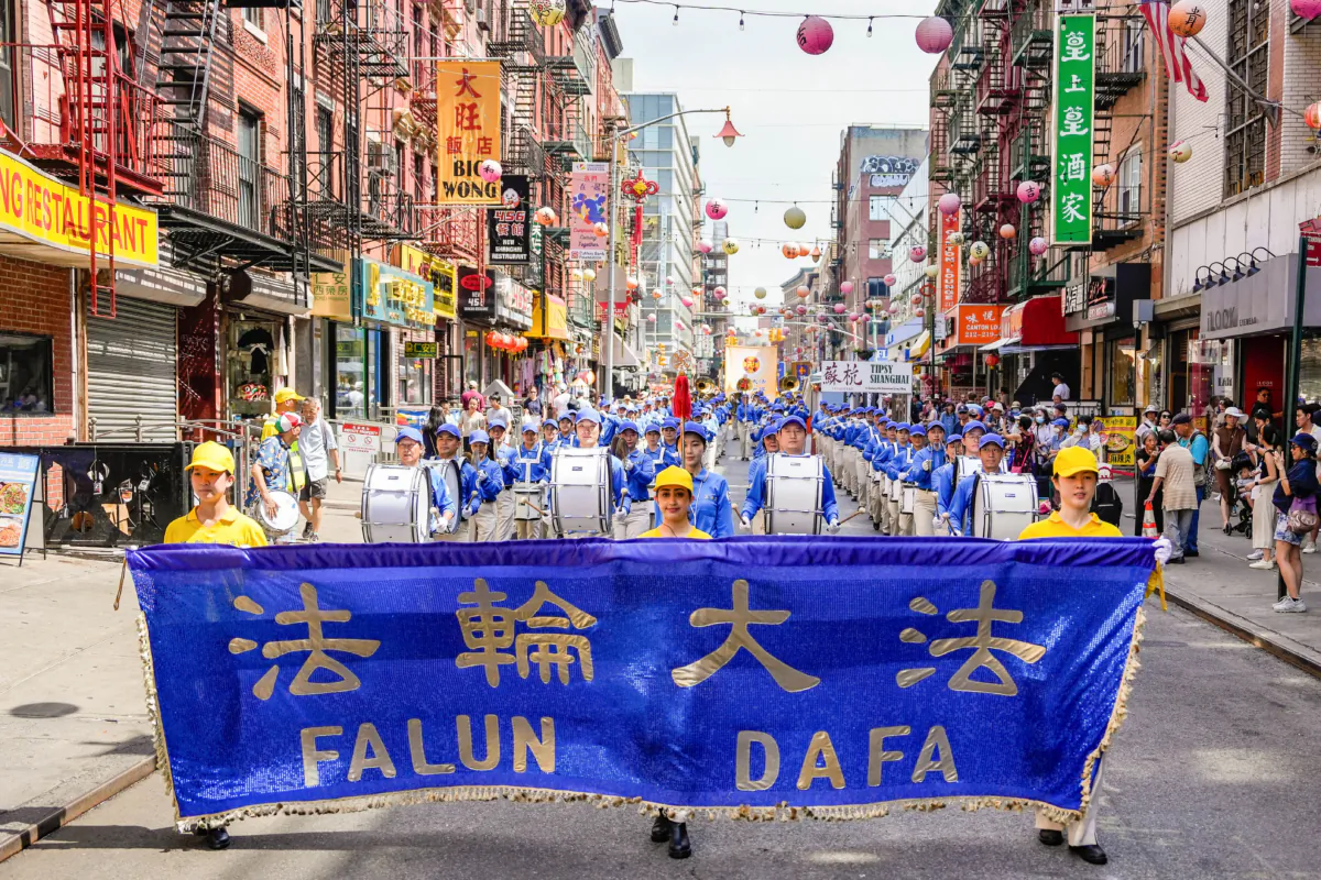 Falun Gong practitioners take part in a parade to commemorate the 24th anniversary of the persecution of the spiritual discipline in China, in New York's Chinatown on July 15, 2023. (Samira Bouaou/The Epoch Times)