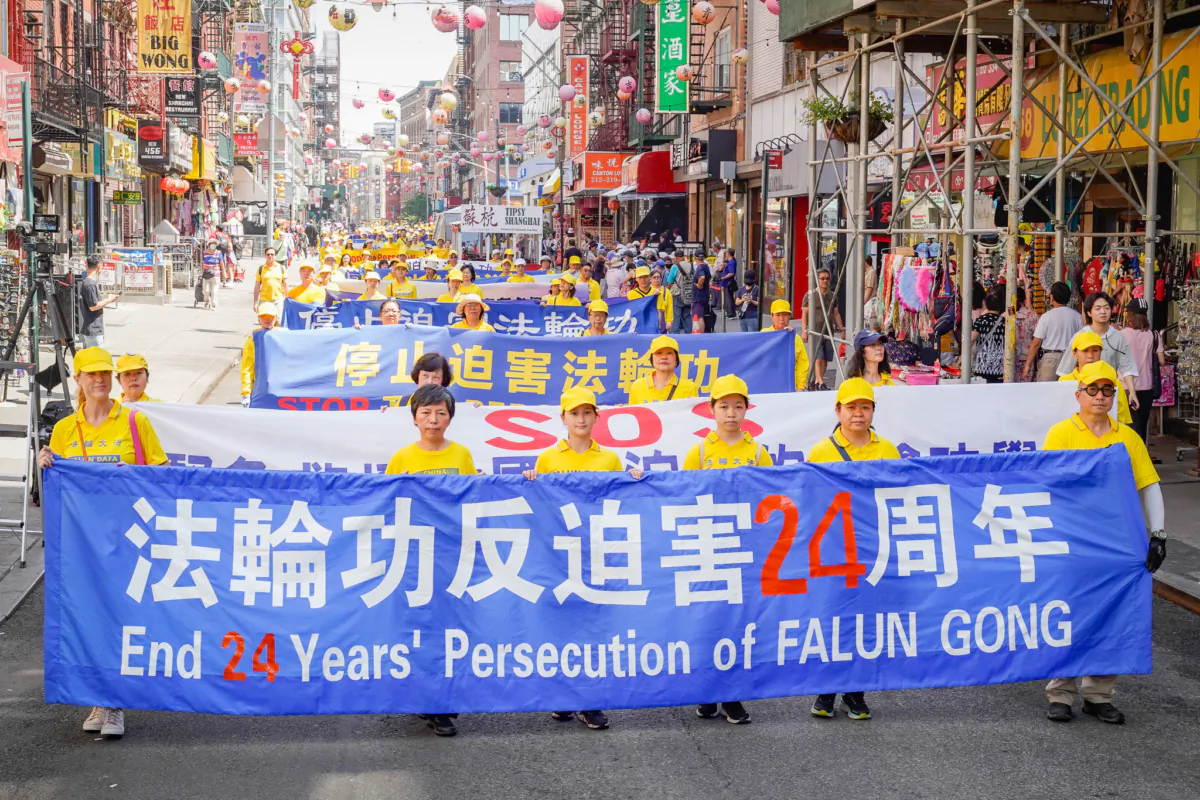 Falun Gong practitioners take part in a parade to commemorate the 24th anniversary of the persecution of the spiritual discipline in China, in New York's Chinatown on July 15, 2023. (Mark Zou/The Epoch Times)