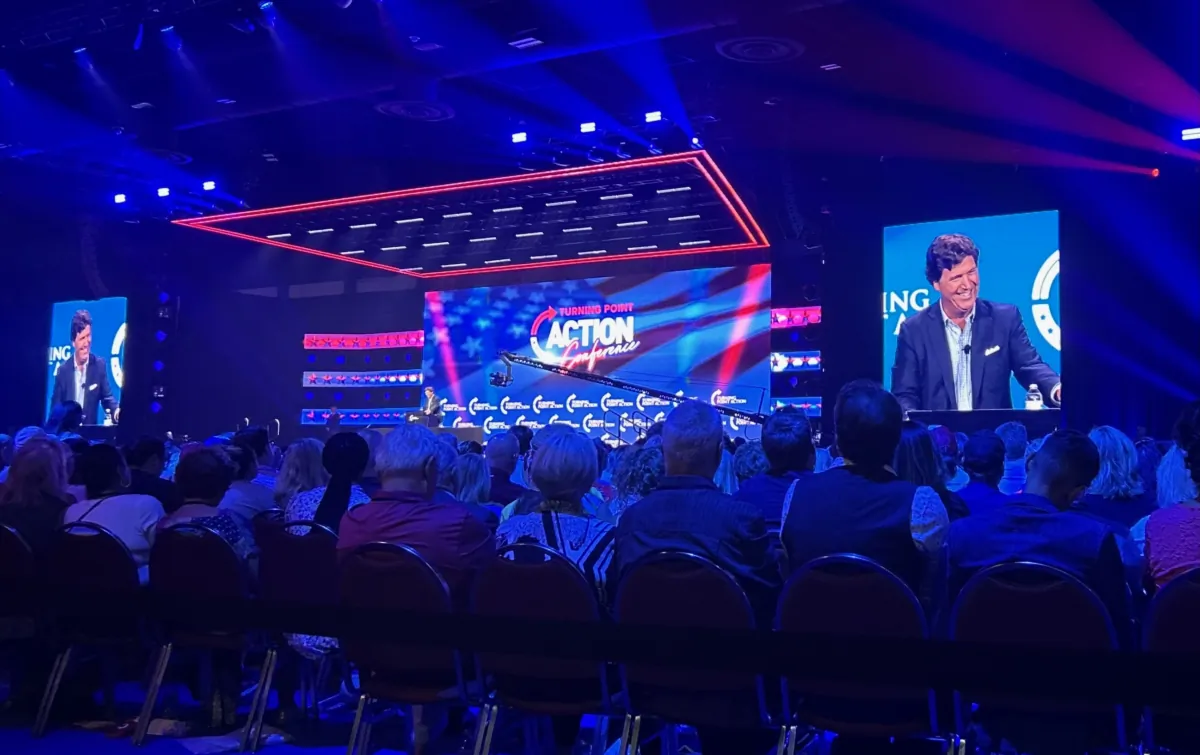 Tucker Carlson delivers a mix of jovial and ominous remarks during the Turning Point Action Conference in West Palm Beach, Fla., on July 15, 2023. (Natasha Holt/The Epoch Times)