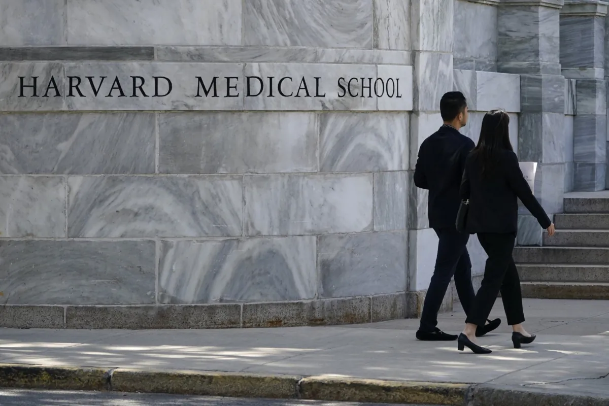 Pedestrians walk towards the Harvard Medical School in Boston on Aug. 18, 2022. (Charles Krupa/AP Photo)