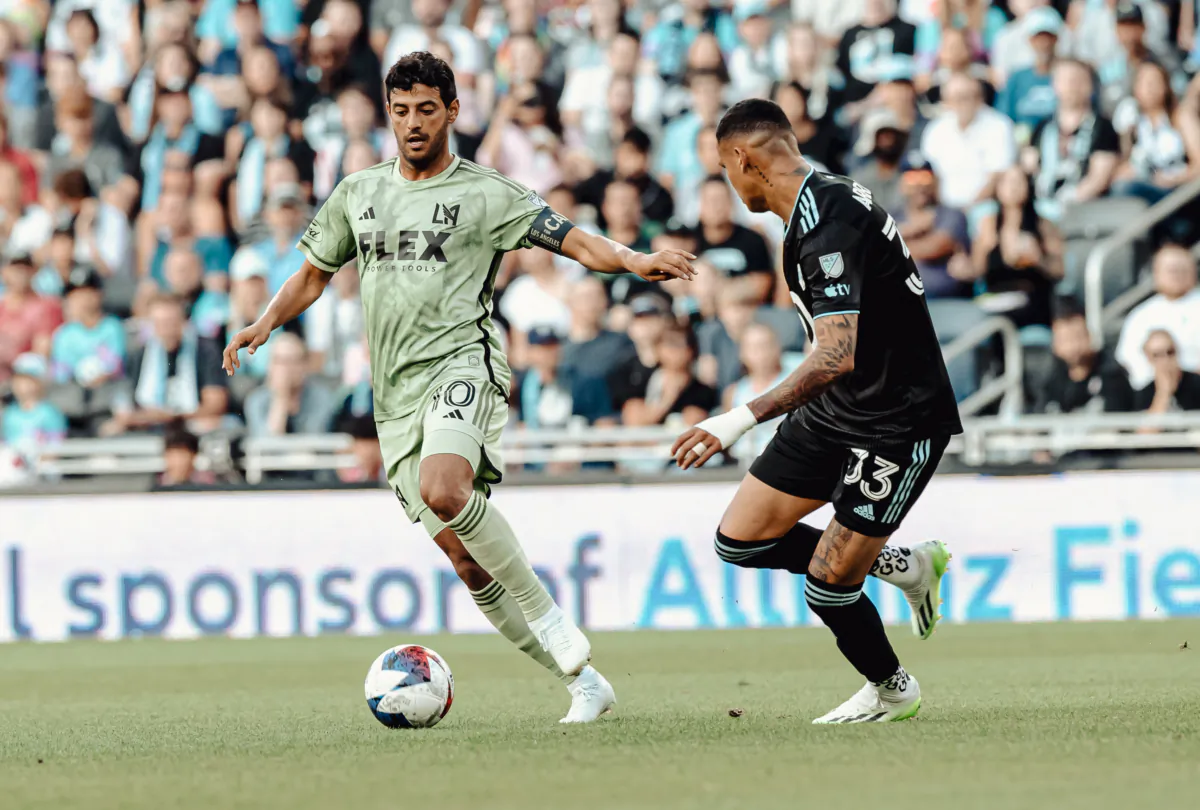 Los Angeles FC forward Carlos Vela (10) dribbles against Minnesota United midfielder Kervin Arriaga (33) at Allianz Field in Saint Paul, Minn., on July 15,2023. (Courtesy of LAFC via The Epoch Times)