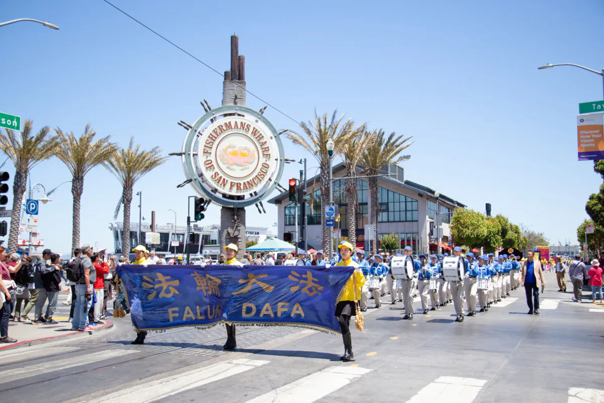 Falun Dafa practitioners march through Fisherman’s Wharf in San Francisco on July 15, 2023. (Lear Zhou/The Epoch Times)