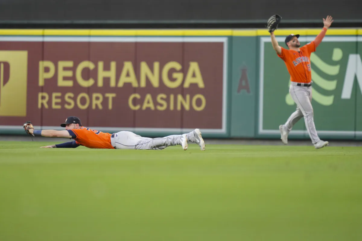 Houston Astros right fielder Kyle Tucker, left, holds on to a caught ball to record the final out as teammate center fielder Chas McCormick (20) reacts to the win during the ninth inning of a baseball game against the Los Angeles Angels in Anaheim, Calif., on July 16, 2023. (Eric Thayer/AP Photo)