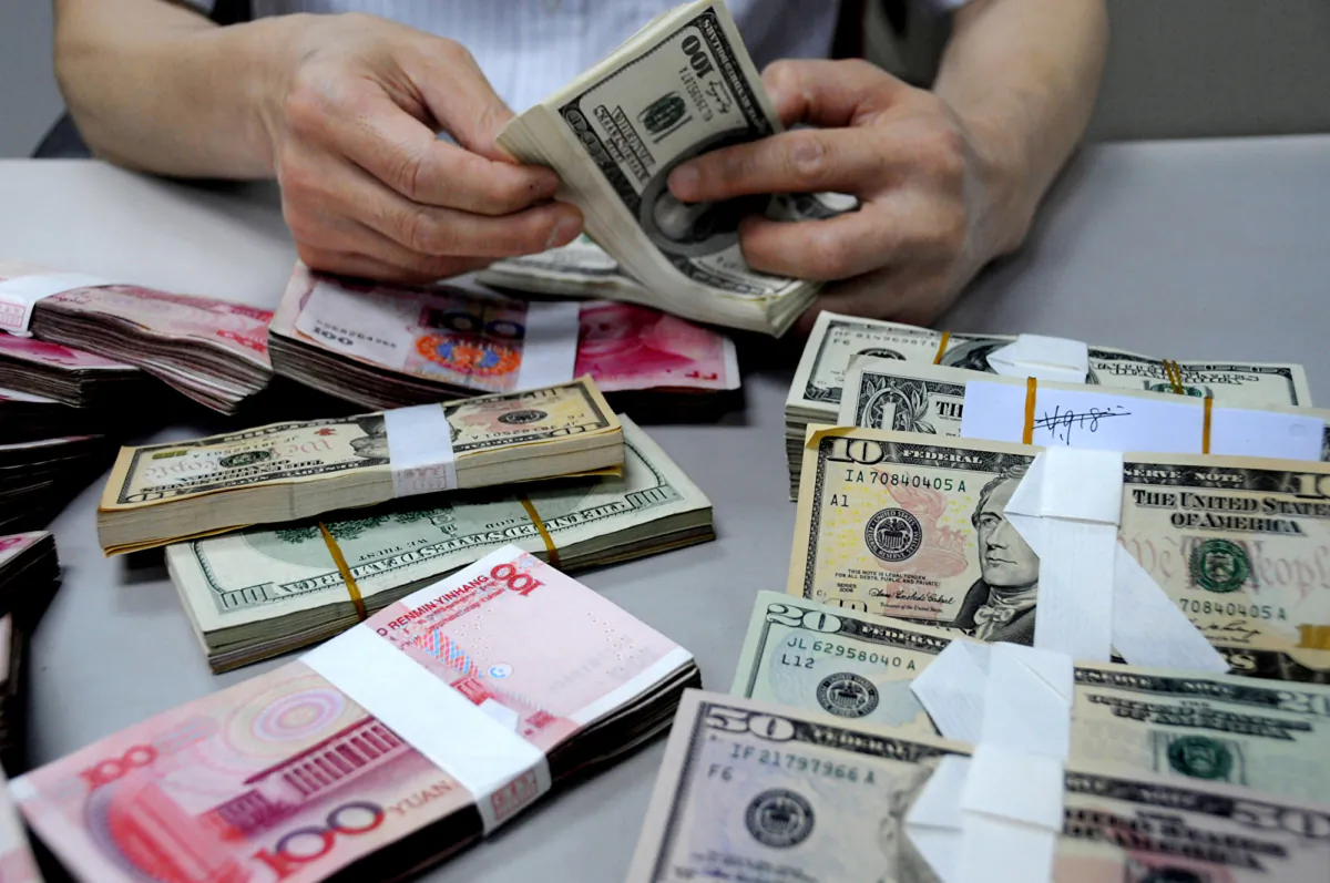 A staff member counts money at a branch of the Bank of China in Lianyungang, Jiangsu Province, China, on Aug. 10, 2011. (VCG/VCG via Getty Images)