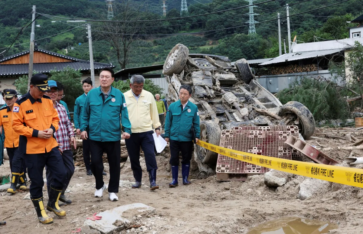 South Korean President Yoon Suk Yeol (4th L), looks around a flood damaged area in Yecheon, South Korea, on July 17, 2023. (Jin Sung-chul/Yonhap via AP)