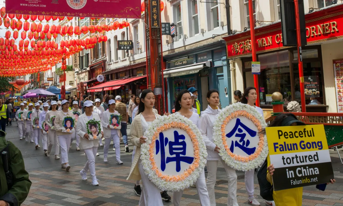 Falun Gong practitioners holding funeral wreaths and and portraits of practitioners killing in China, in a rally marking the 24th anniversary of the CCP's persecution against Falun Gong, in London on July 15, 2023. (Yanning Qi/The Epoch Times)