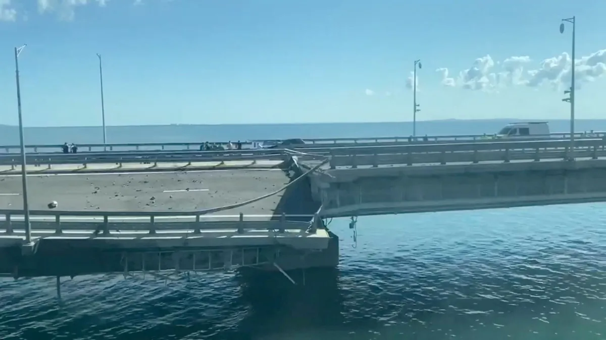 The section of a road split and sloping to one side following an attack on the Crimea Bridge in this still image taken from video released on July 17, 2023. (Сrimea24tv/Handout via Reuters)