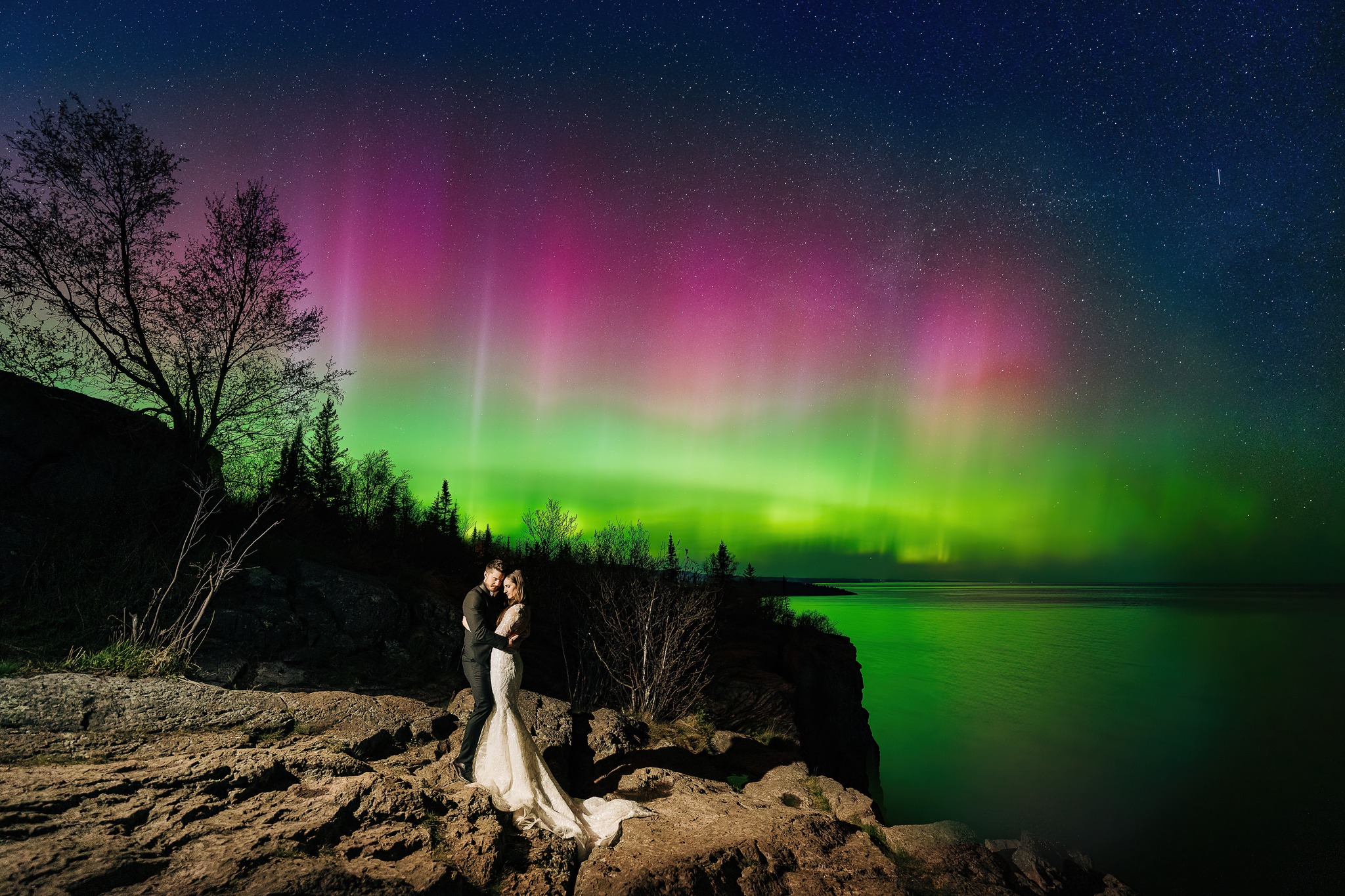 Mr. and Ms. Johnson's wedding photo with the Northern Lights in the background.