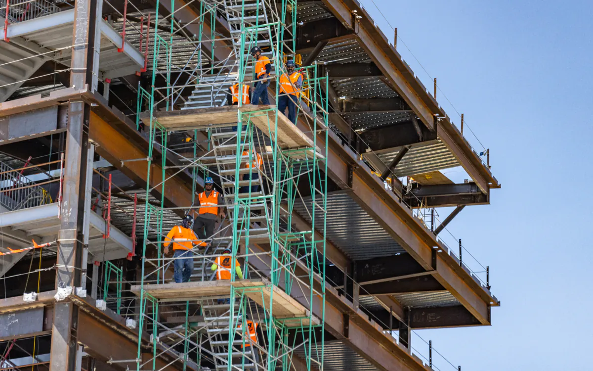Construction crews work to complete a new medical facility at the University of California–Irvine in Irvine, Calif., on July 13, 2023. (John Fredricks/The Epoch Times)