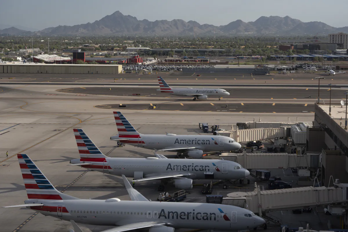 An American Airlines plane taxis past planes at their gates at Sky Harbor International Airport on July 12, 2023, in Phoenix. Tuesday marked the Phoenix-area's 12th consecutive day of temperatures reaching over 110 degrees, as a record-breaking heat wave continues across the Southwest. (Rebecca Noble/Getty Images/TNS)