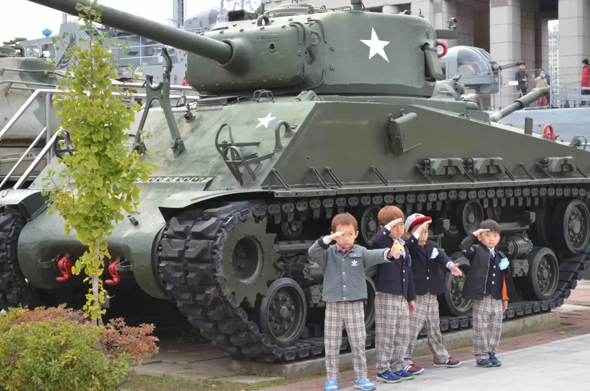 South Korean children stand in front of a tank at the War Memorial of Korea, Seoul, South Korea, in this undated photograph. (Courtesy of Dustin Bass/The Sons of History)