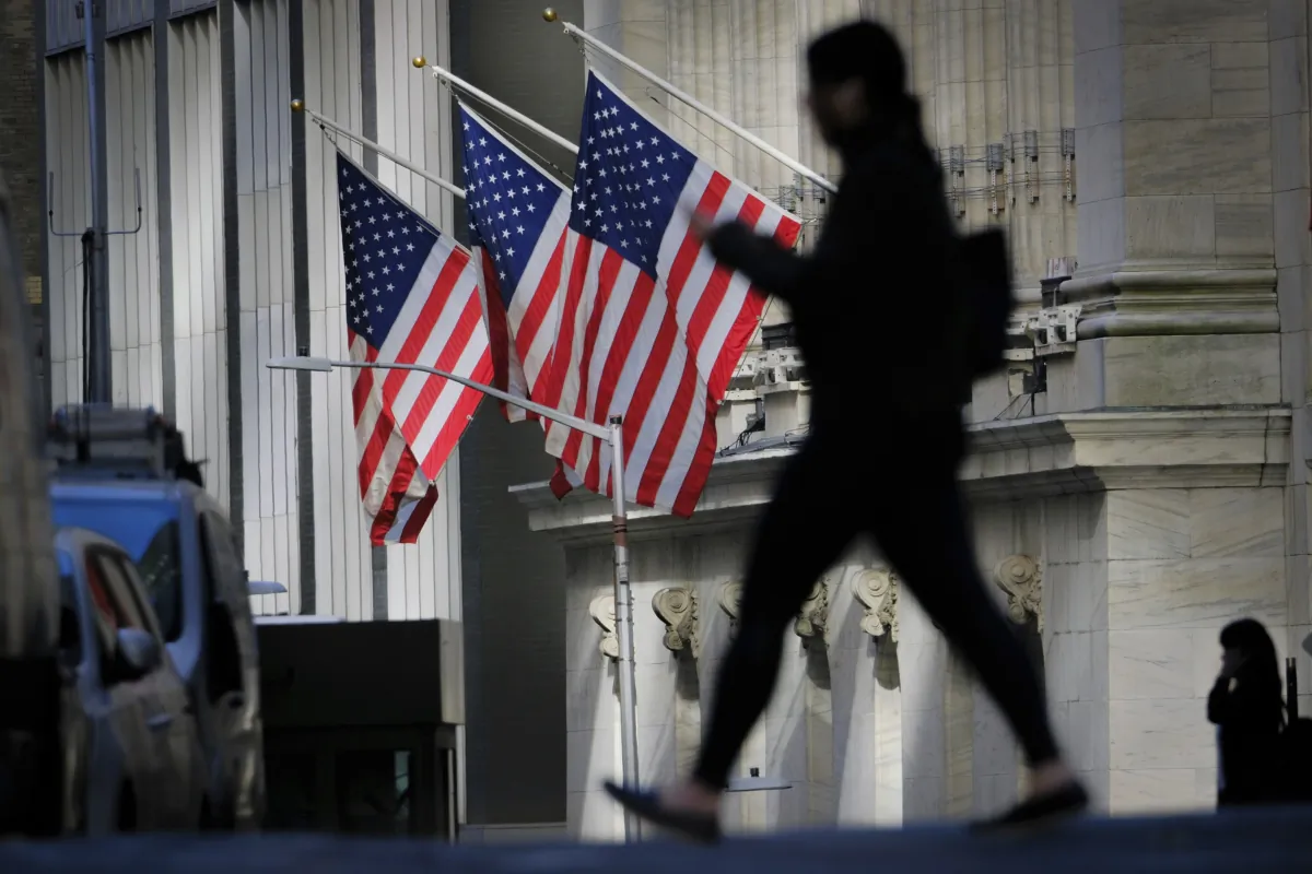 A pedestrian walks past the New York Stock Exchange in New York on Oct. 27, 2022. (J. David Ake/AP Photo)