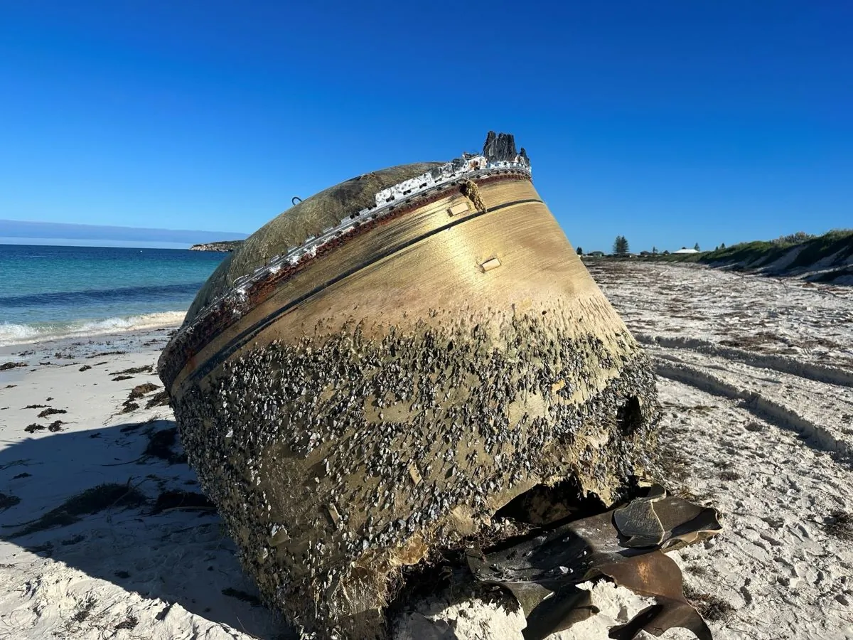 A supplied image obtained on Monday, July 17, 2023, of a cylindrical piece of equipment that has washed up on the beach at Green Head, about 250 kilometres north of Perth, WA. (AAP Image/Supplied by Australian Space Agency)