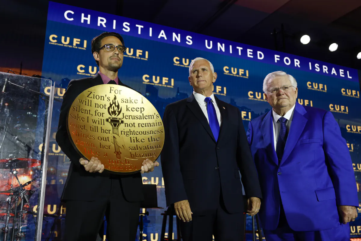 Republican presidential candidate, former Vice President Mike Pence is given the "Defender of Israel" award by the founder and National Chairman for Christians United For Israel (CUFI), evangelical pastor John Hagee (R) during the 2023 Christians United for Israel summit in Arlington, Virginia, on July 17, 2023. (Anna Moneymaker/Getty Images)