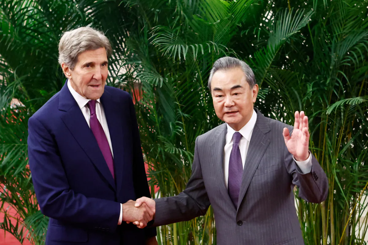 U.S. Climate Envoy John Kerry and China's top diplomat Wang Yi (R) shake hands before a meeting at the Great Hall of the People in Beijing on July 18, 2023. (Florence Lo/POOL/AFP via Getty Images)