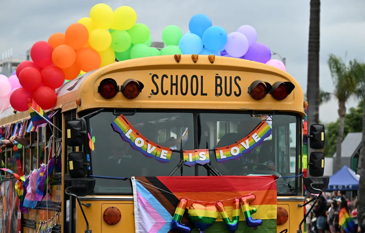 A school bus adorned with rainbow colors is the YMCA entry to the 2023 LA Pride Parade in Hollywood, Calif., on June 11, 2023. (Robyn Beck/AFP via Getty Images)
