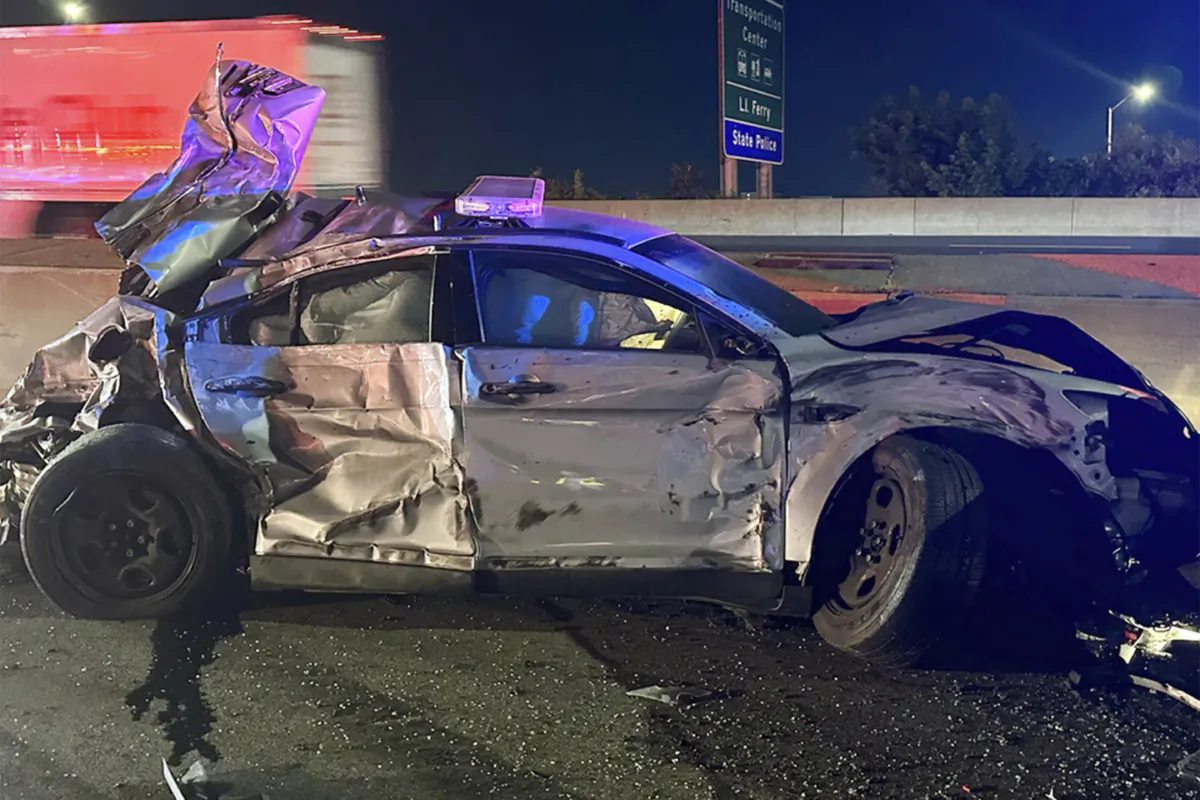 One of two state police cruisers damaged when human waste, leaking from a tractor trailer, turned at Interstate 95 in Bridgeport, Conn., in an image released on July 18, 2023, into a virtual skating rink, causing multiple crashes on July 17, 2023. (Connecticut State Police via AP)