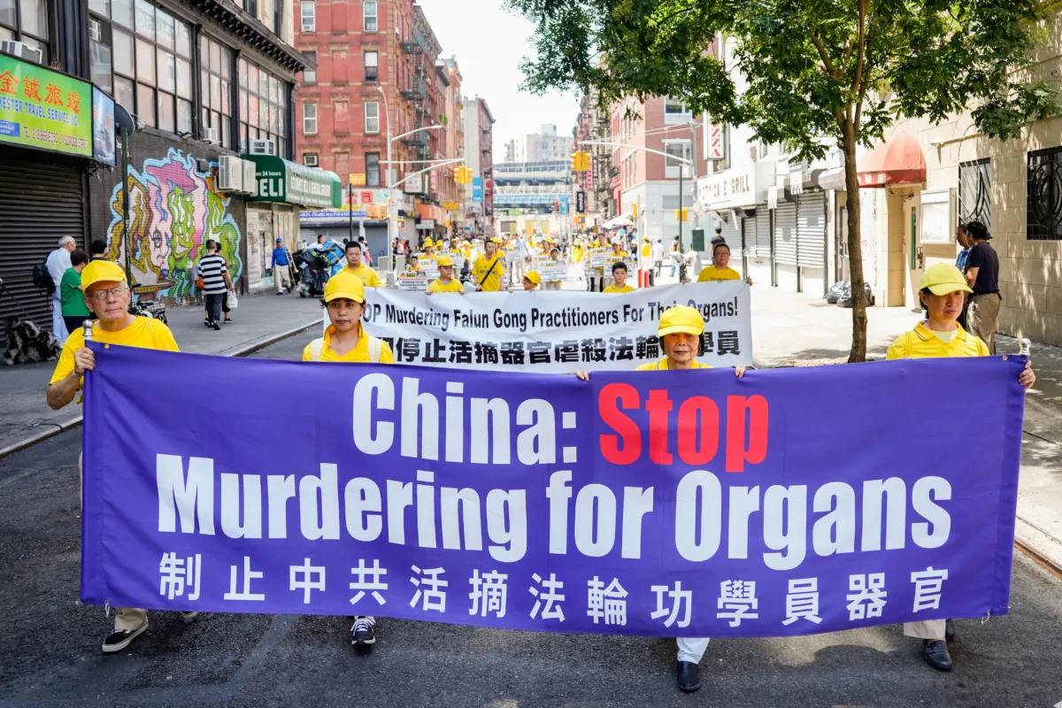 Falun Gong adherents take part in a march to commemorate the 24th anniversary of the persecution of the spiritual discipline in China, in New York's Chinatown on July 15, 2023. (Samira Bouaou/The Epoch Times)