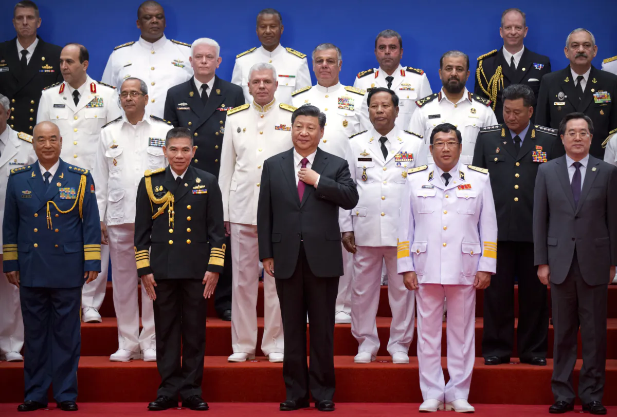 Chinese leader Xi Jinping (front-C) and Chinese and foreign naval officials pose for a group photo during an event to commemorate the 70th anniversary of the Chinese People's Liberation Army (PLA) Navy in Qingdao, in eastern China's Shandong province, on April 23, 2019. (Schiefelbein /AFP via Getty Images)