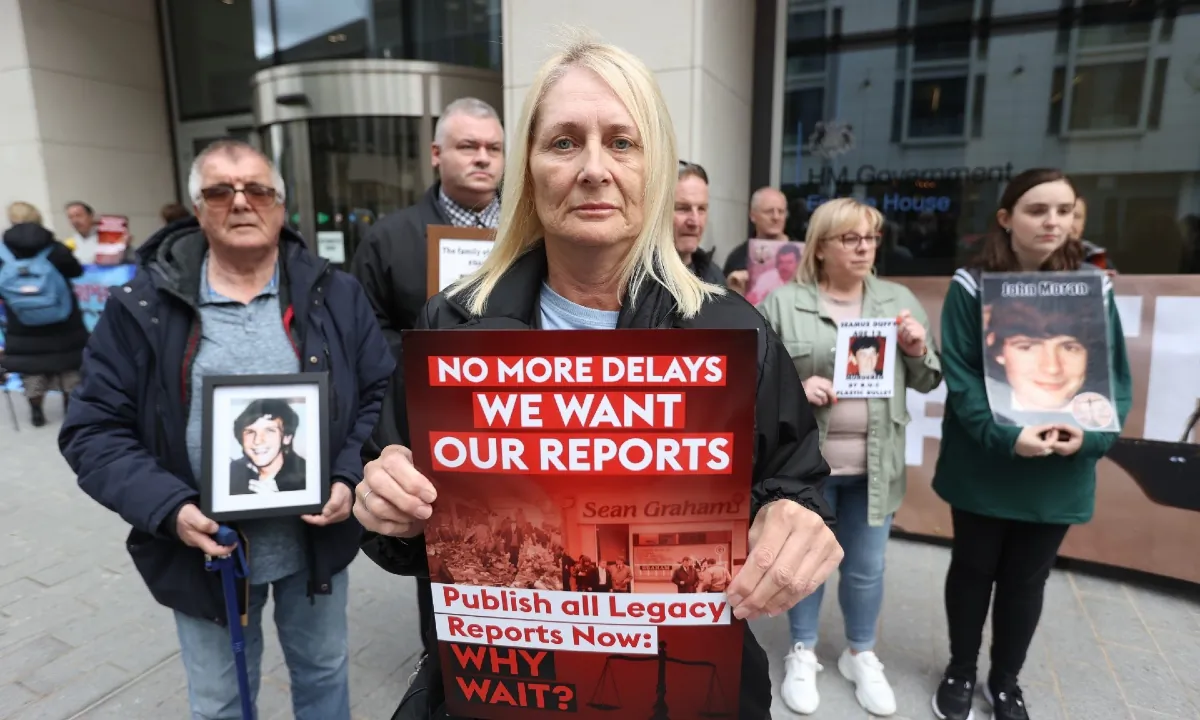 Patricia Burns, whose father Thomas Burns was shot dead by a British soldier in 1972 with other Time for Truth and Justice campaigners outside the Northern Ireland Office at Erskine House in Belfast on May 11, 2023. (PA Media)