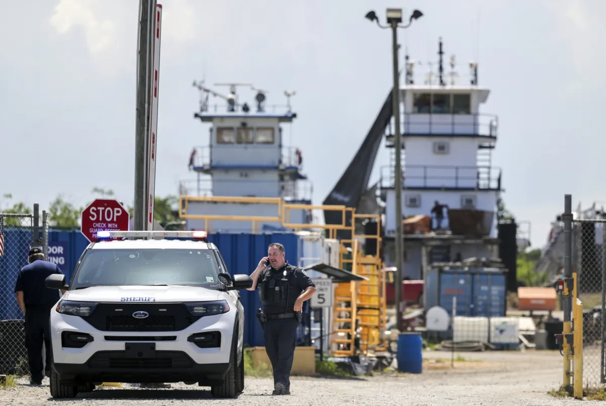 A Jefferson Parish sheriff's deputy at FMT Shipyard and Repair after two employees were shot and killed in Harvey, La., on July 17, 2023. (Brett Duke/The Times-Picayune/The New Orleans Advocate via AP)