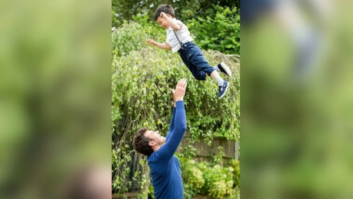 A father throws his son into the air while playing outdoors. (Suzi Anna via GJW)