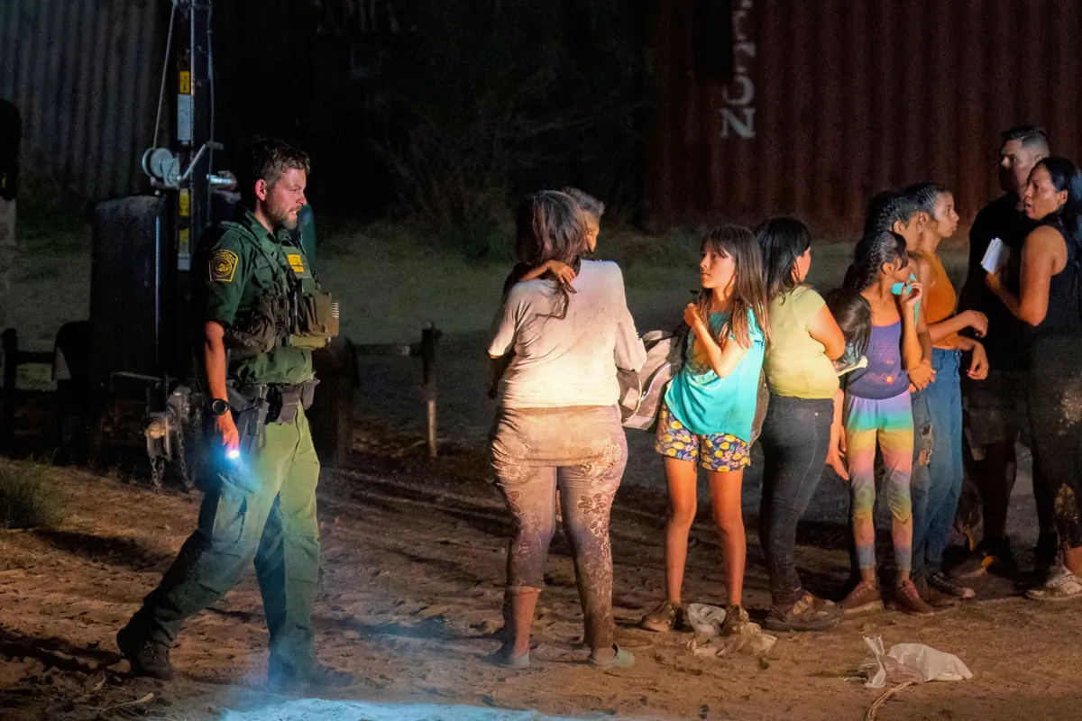 Illegal immigrants wait to be taken by Border Patrol to a processing facility to begin their asylum-seeking process in Eagle Pass, Texas, on June 25, 2023.  (Suzanne Cordeiro/AFP via Getty Images)