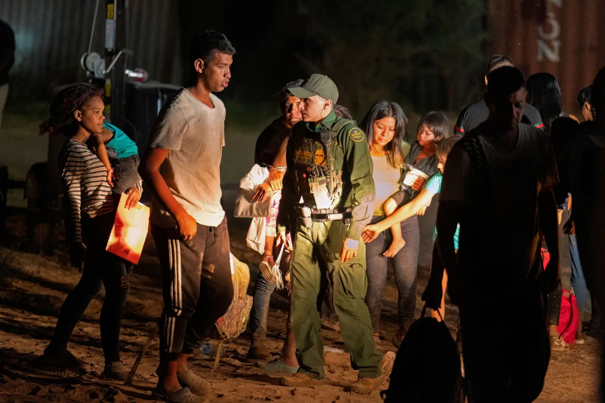 Illegal immigrants wait to be taken by Border Patrol to a processing facility to begin their asylum-seeking process in Eagle Pass, Texas, on June 25, 2023. (Suzanne Cordeiro/AFP via Getty Images)