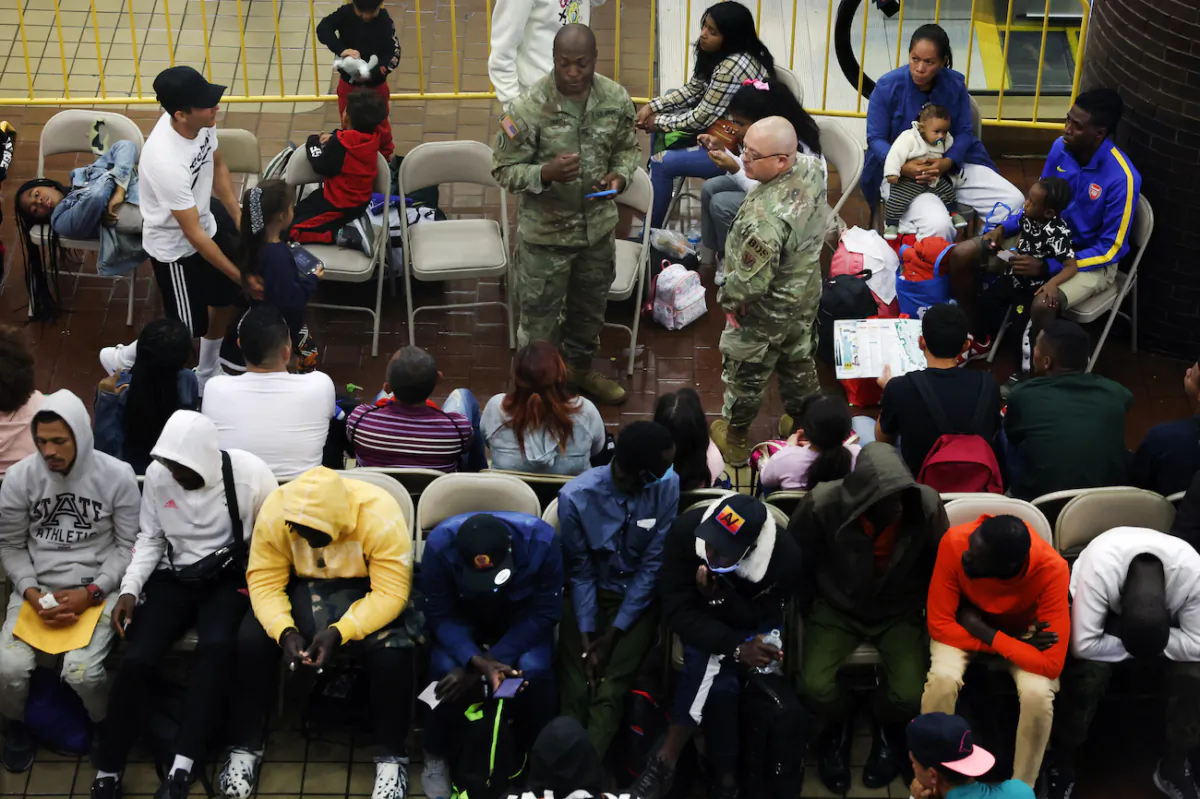 Newly arrived illegal immigrants wait in a holding area at the Port Authority bus terminal before being sent off to area shelters and hotels in New York City, on May 15, 2023.(Spencer Platt/Getty Images)