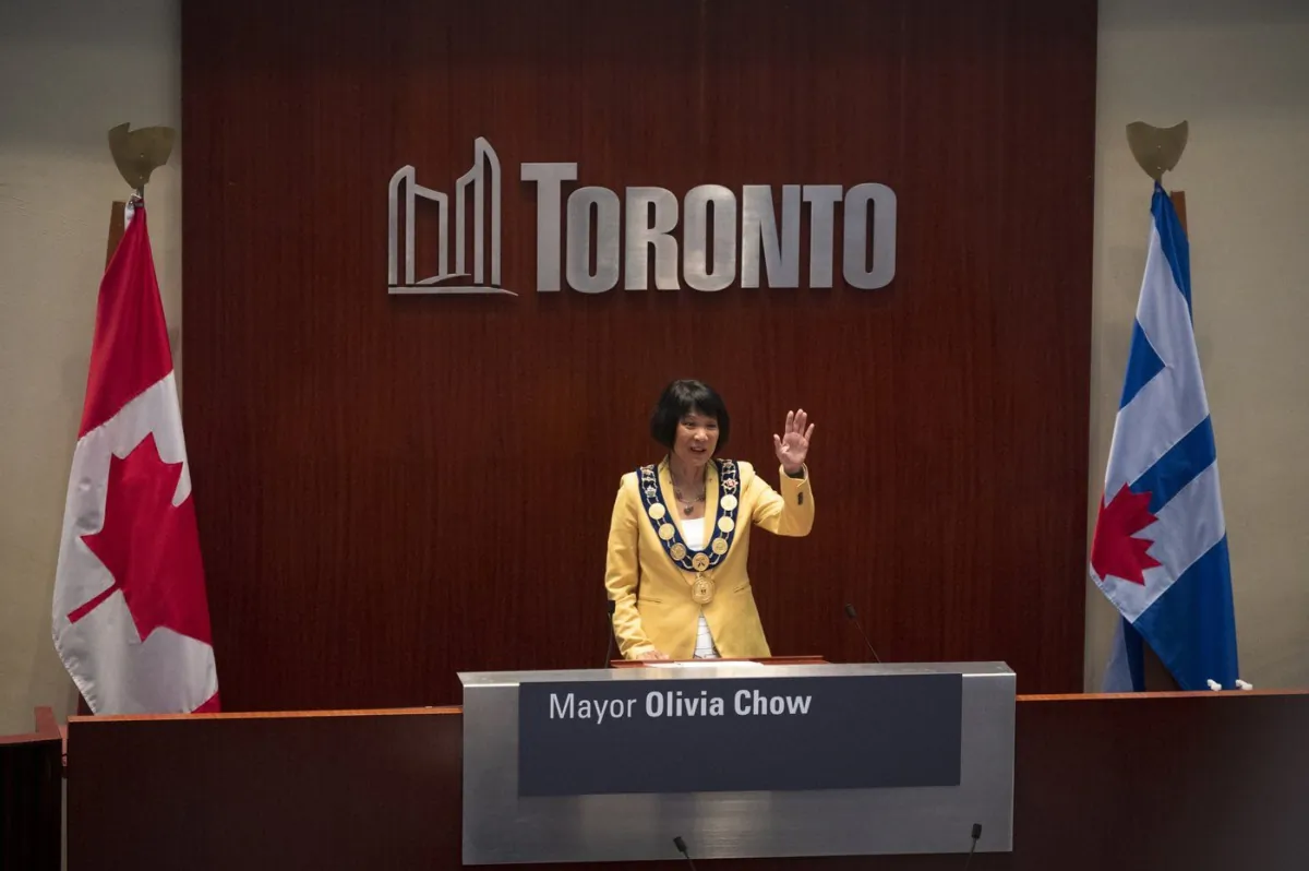 Newly elected Mayor Olivia Chow waves to the crowd at council chambers during her Declaration of Office Ceremony at Toronto City Hall in Toronto on July 12, 2023. (The Canadian Press/Tijana Martin)
