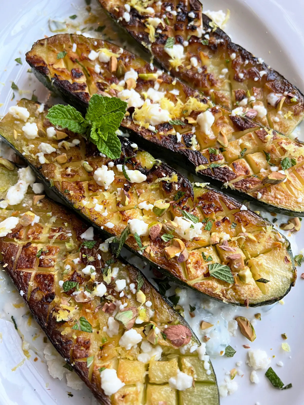 Pan-roasted zucchini nestled on a tangy feta-lemon sauce and topped with more feta, mint and crushed pistachio. (Gretchen McKay/Pittsburgh Post-Gazette/TNS)