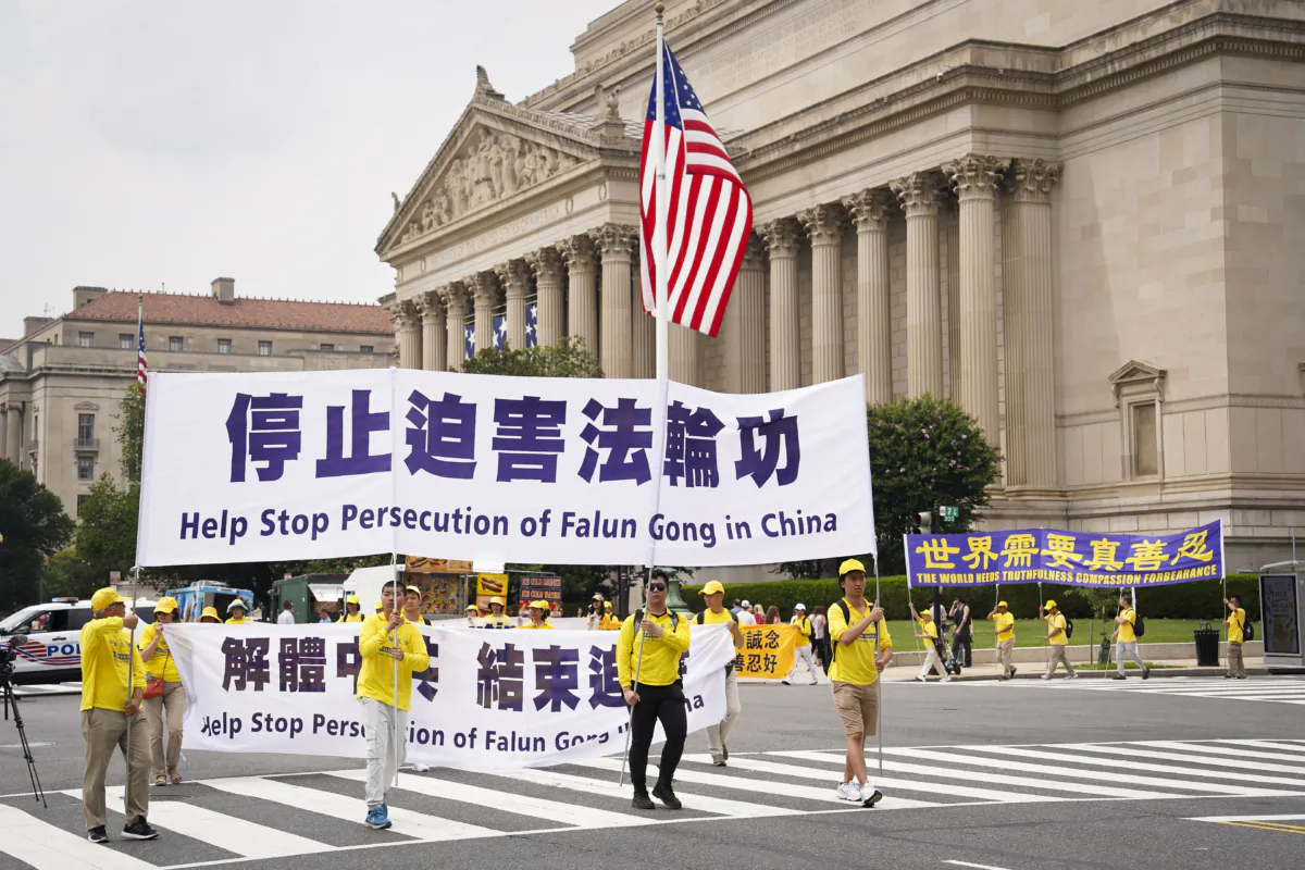 Falun Gong practitioners take part in a parade to mark the 24th anniversary of the persecution of the spiritual discipline in China by the Chinese Communist Party at the National Mall in Washington on July 20, 2023. (Madalina Vasiliu/The Epoch Times)