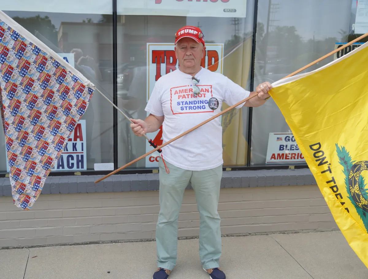 A grassroots activist protesting against the indictment of 16 Michigan GOP electors outside of a press conference in Macomb County, Mich., on July 19, 2023. (Steven Kovac/The Epoch Times)