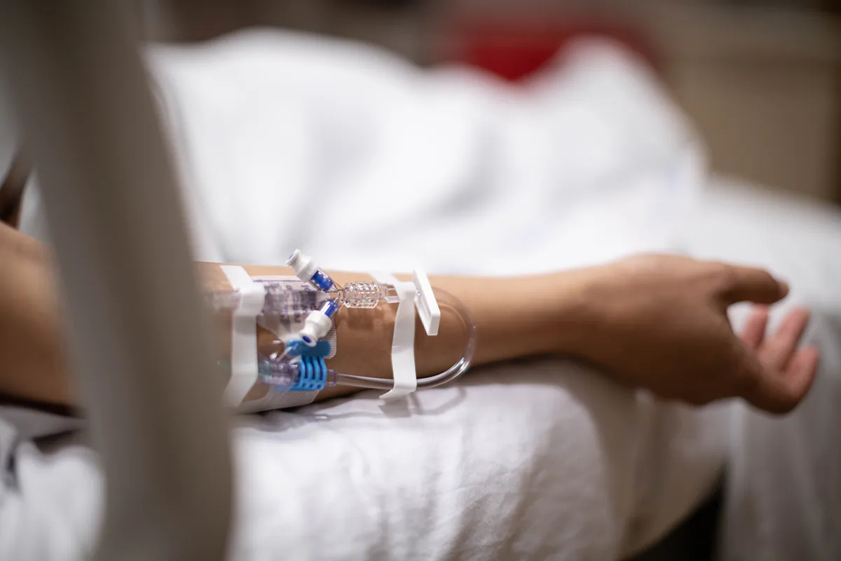 A hospitalized patient lies in in bed while connected to an IV drip tube in this file photo. (Shutterstock)