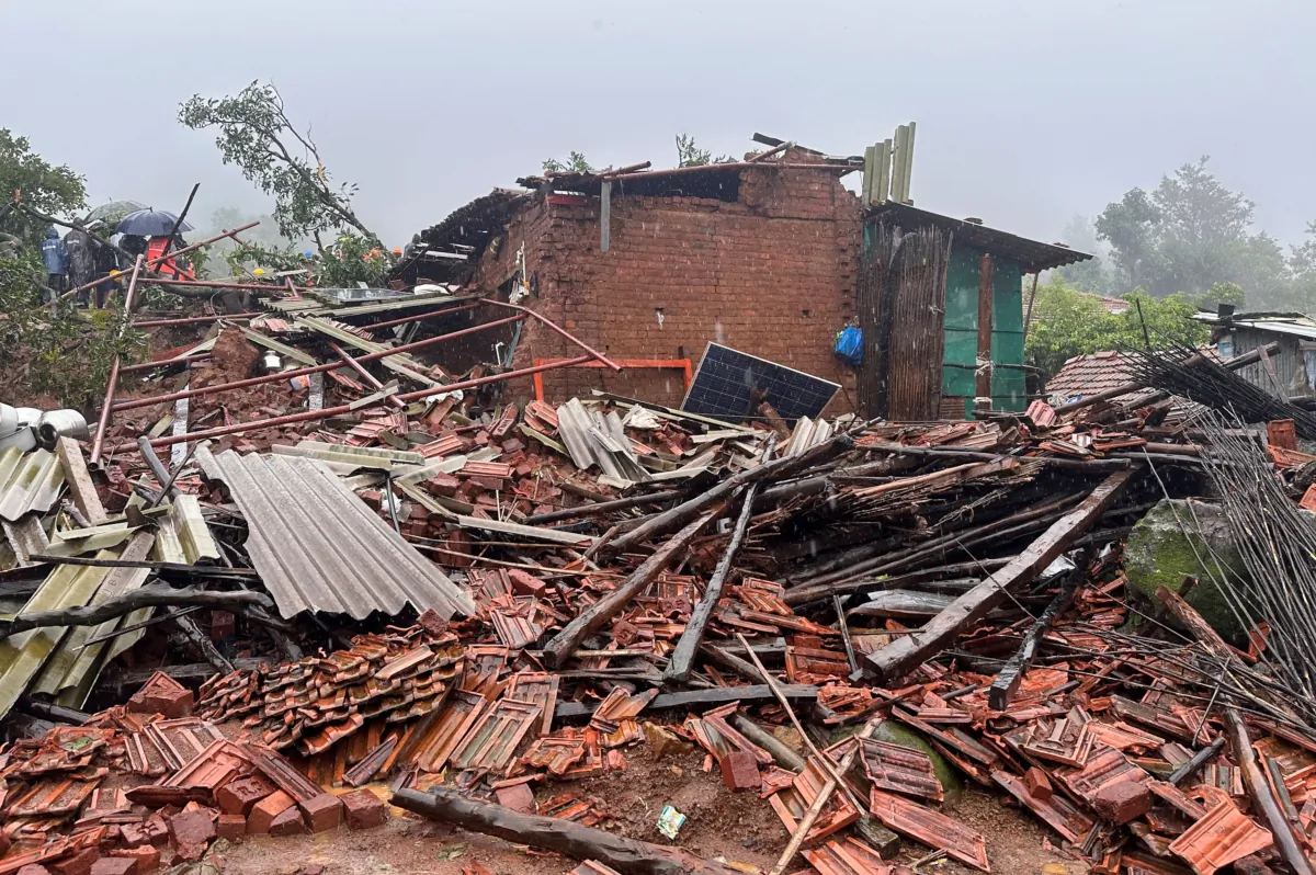 Rescuers stand next to debris of a residential house that was damaged by a landslide in Raigad district in the western state of Maharashtra, India, on July 20, 2023. (Francis Mascarenhas/Reuters)