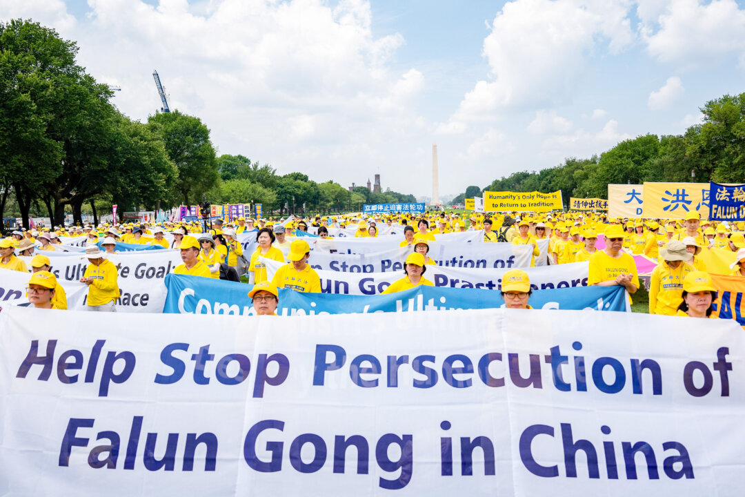 Falun Gong believers call for an end to the persecution of the spiritual group in China, during an event marking 24 years since the launch of the persecution, on Capitol Hill on July 20, 2023. (Samira Bouaou/The Epoch Times)