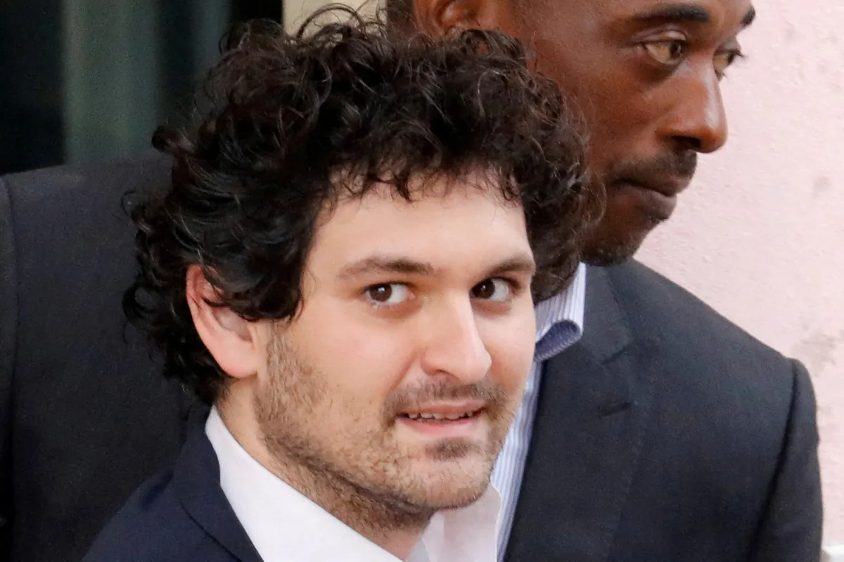 Sam Bankman-Fried, the founder and former CEO of crypto currency exchange FTX, is escorted out of the Magistrate Court building in Nassau, Bahamas, on Dec. 21, 2022. (Marco Bello/Reuters)