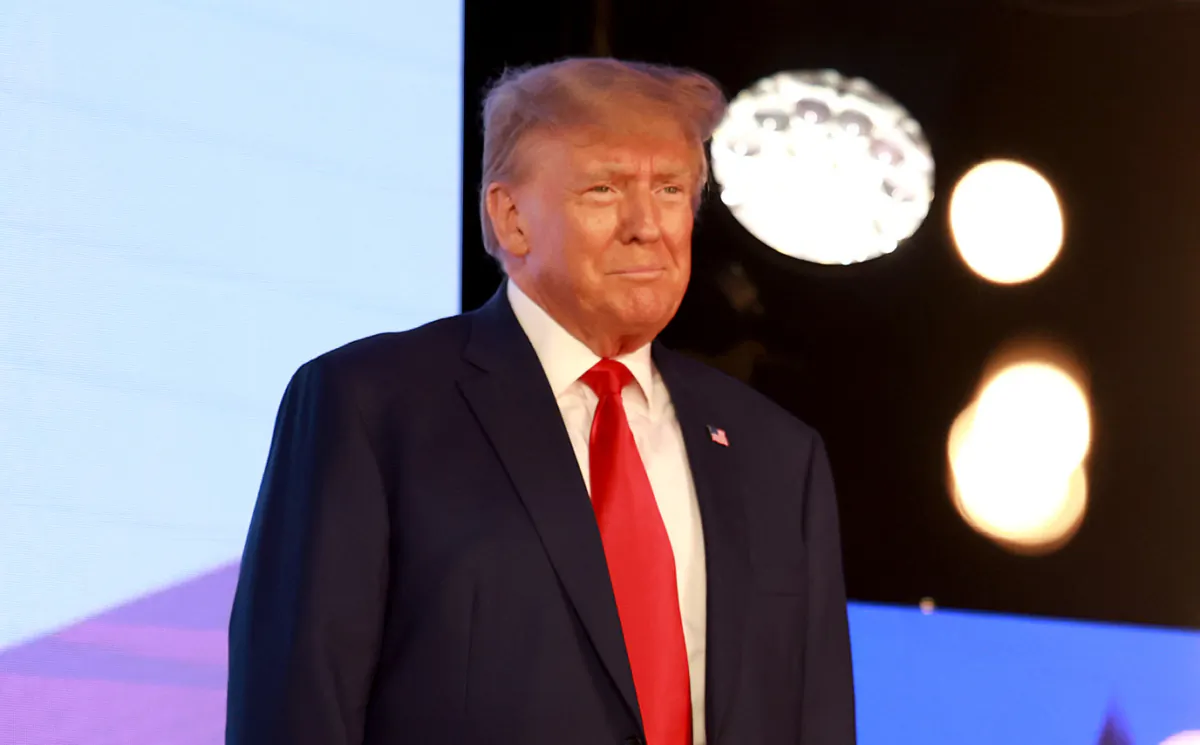 Former President Donald Trump arrives on stage to speak at the Turning Point Action conference in West Palm Beach, Fla., on July 15, 2023. (Joe Raedle/Getty Images)