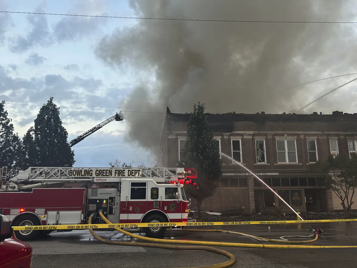 Members of the Bowling Green Fire Department work to extinguish an early morning structure fire on State Street in Bowling Green, Ky., on July 21, 2023. (Jake Moore/Daily News via AP)