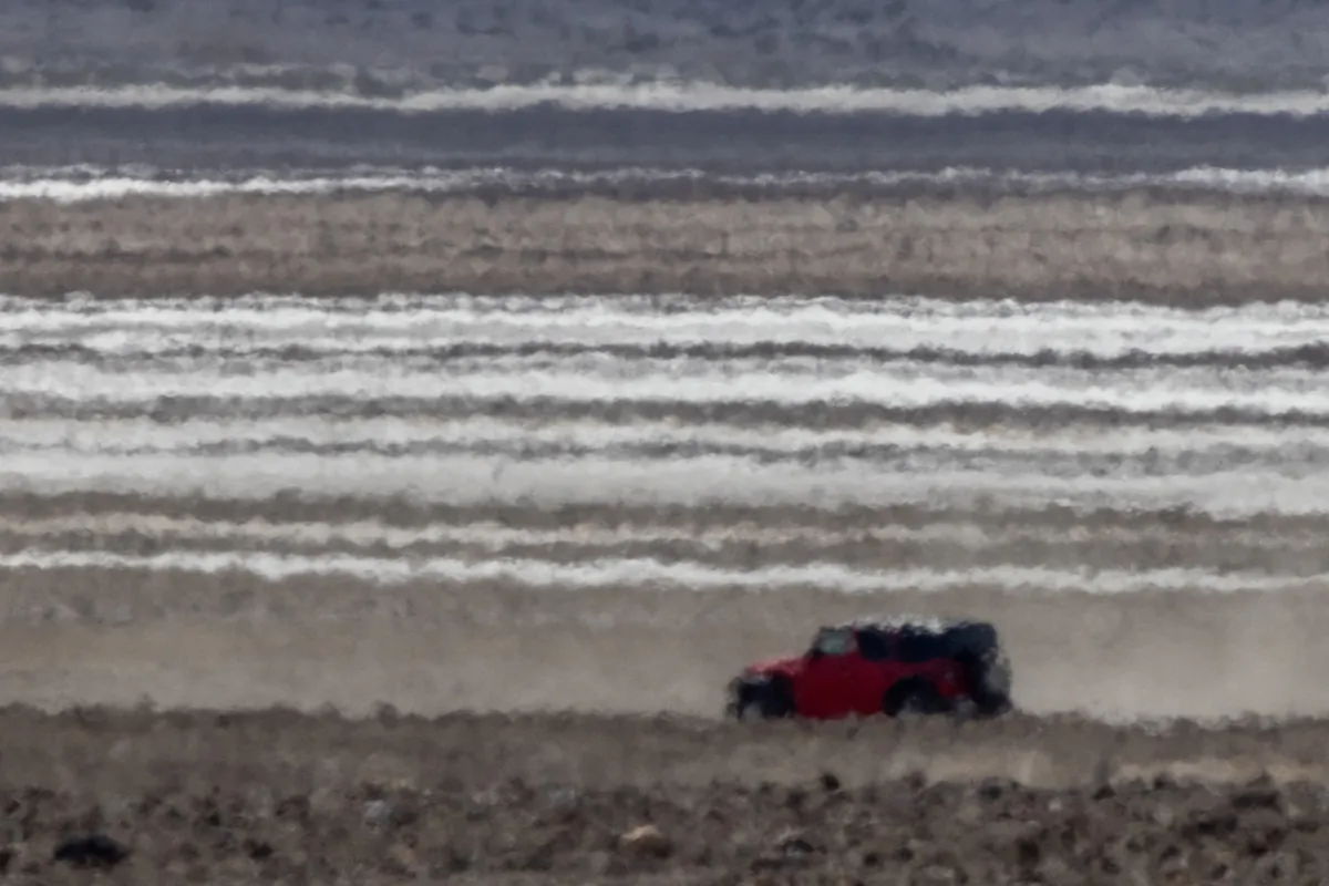 A Jeep is distorted in the heat haze as the temperature rises past about 127 degrees Fahrenheit in Death Valley National Park near Furnace Creek, Calif., on July 16, 2023. (David McNew/Getty Images)