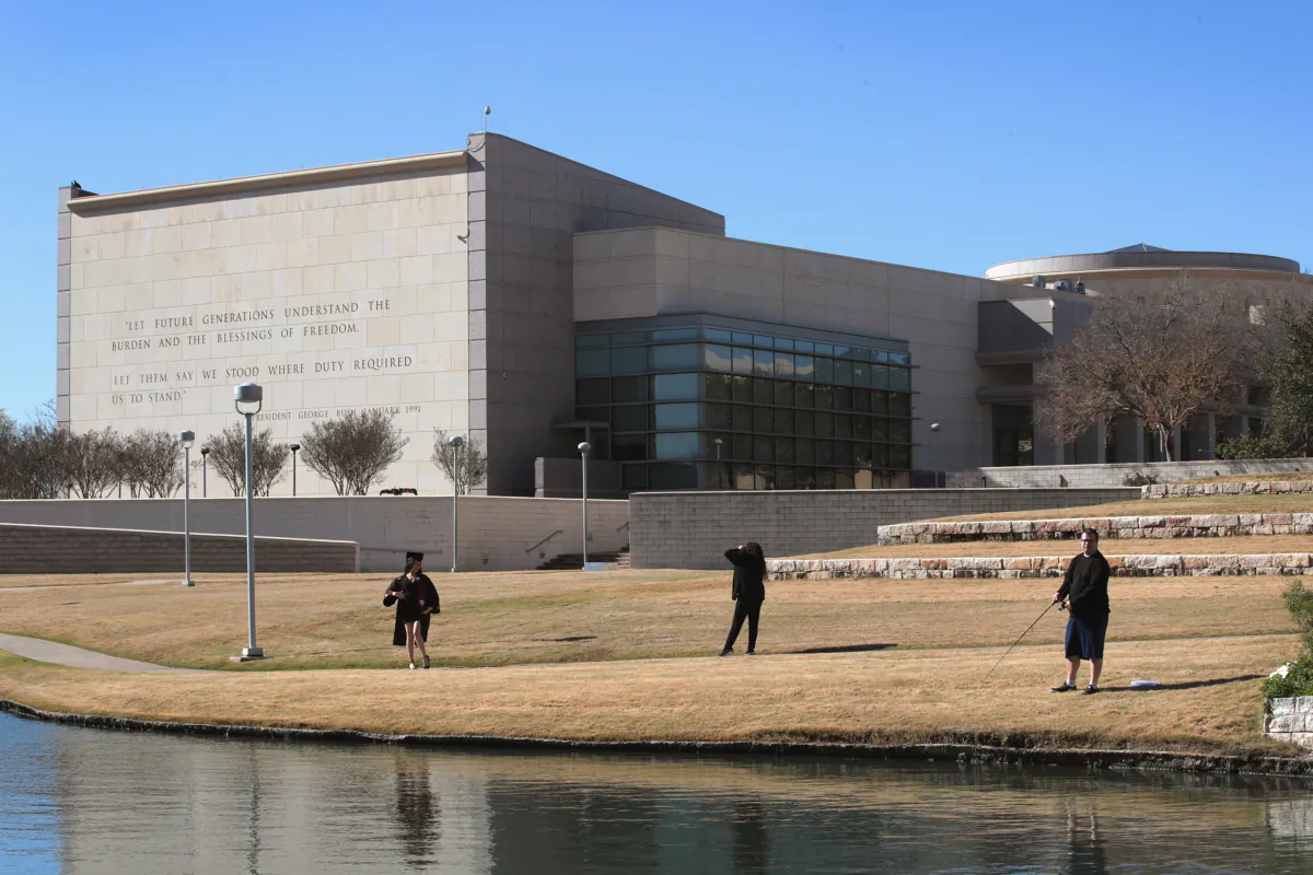 Visitors walk along a pond behind the George H.W. Bush Presidential Library Center on the campus of Texas A&M University in College Station, Texas, on Dec. 2, 2018. (Scott Olson/Getty Images)